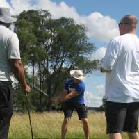 man hits while others watch